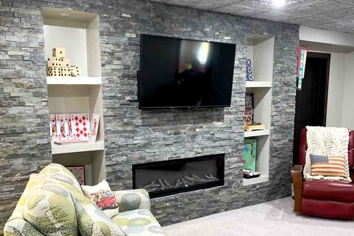 basement remodel with stone wall and TV in Central Illinois by True Craft Remodelers