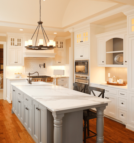 marble island counteretop with light grey and white cabinets