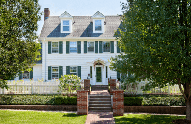 exterior of white home with brick stairs
