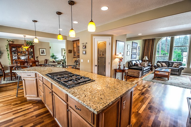 a kitchen with a stove top oven sitting on top of a wooden floor.