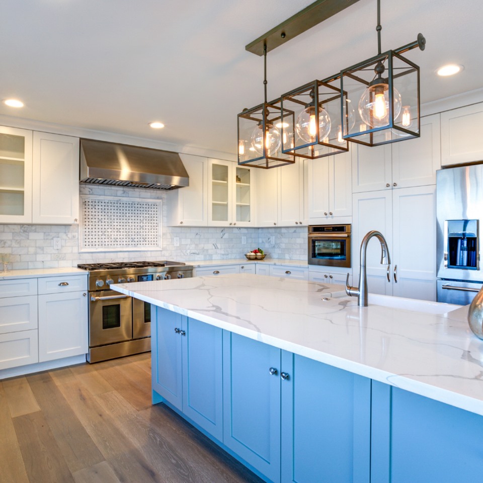 Large kitchen with blue colored cabinets & marble counter top by True Craft Remodeler, Central Illinois