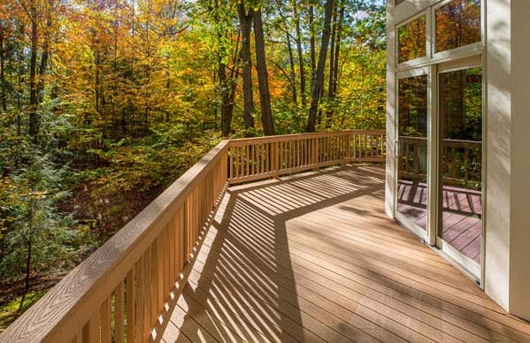 Composite Deck In The Woods With Large Sliding Glass Doors By True Craft Remodelers