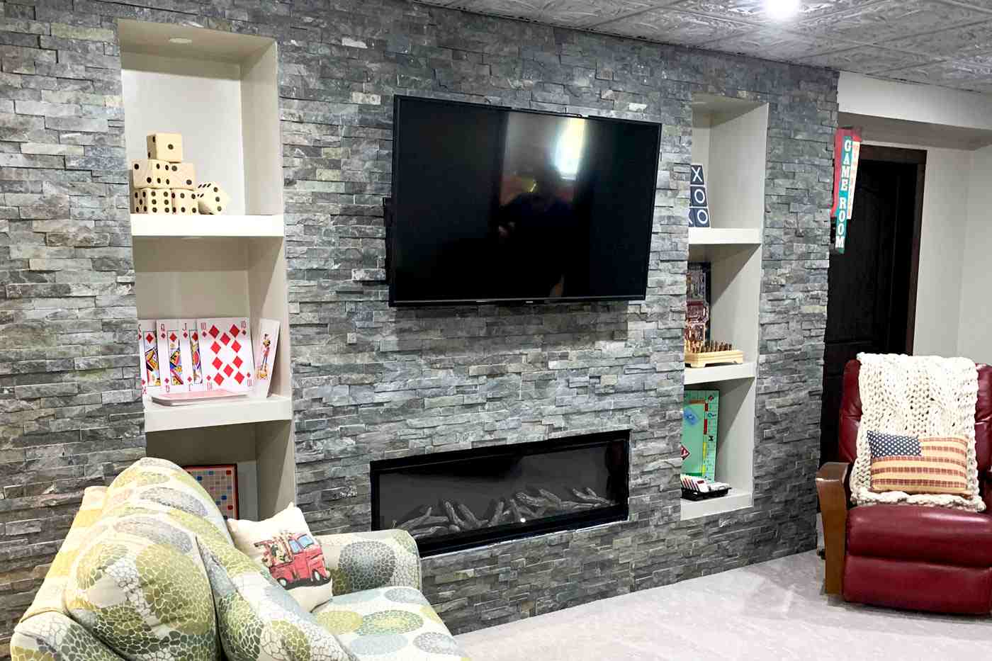 Basement with stone wall with custom storage by True Craft Remodelrs in Illinois