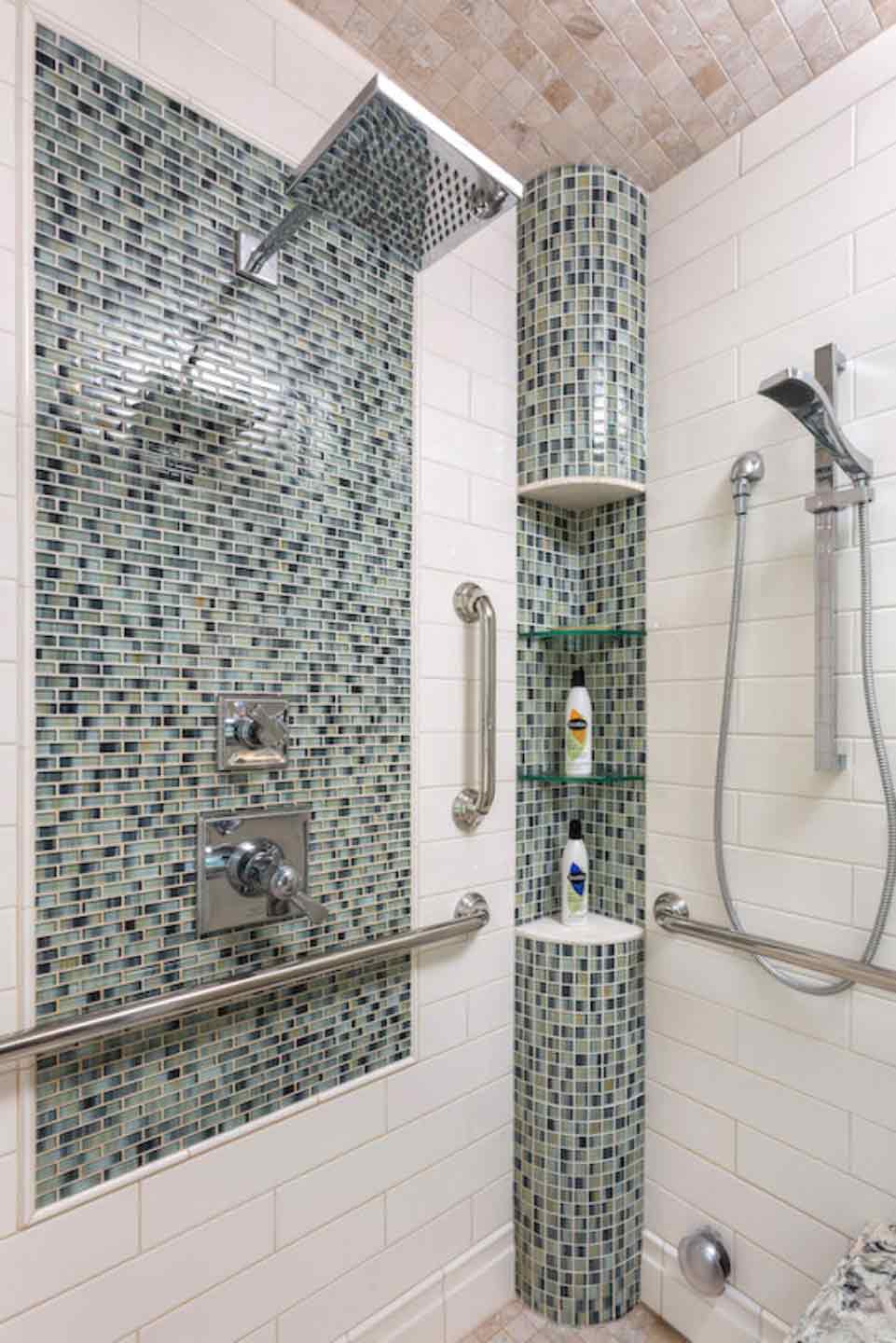 Mosaic tiled bathroom shower with corner shelving and ADA accessible.