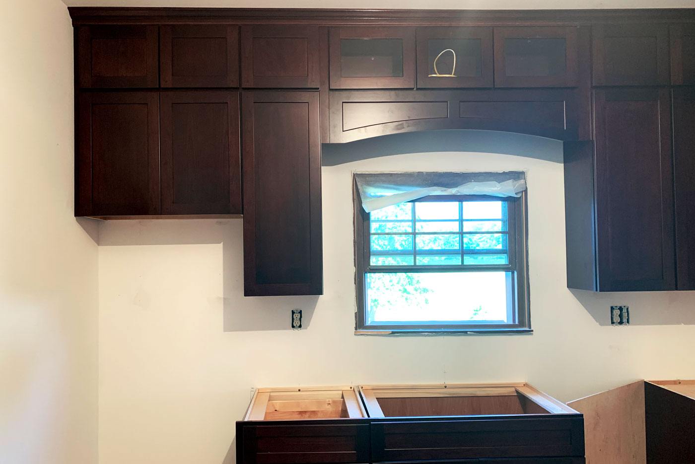 Kitchen remodel with dark brown cabinets being installed by True Craft Remodelrs in Illinois