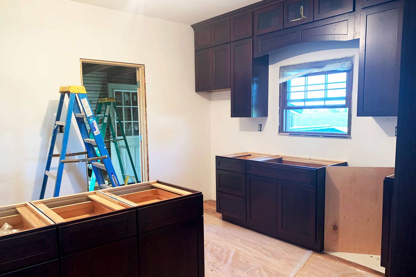 new cabinets being installed in a kitchen by True Craft Remodelrs in Illinois