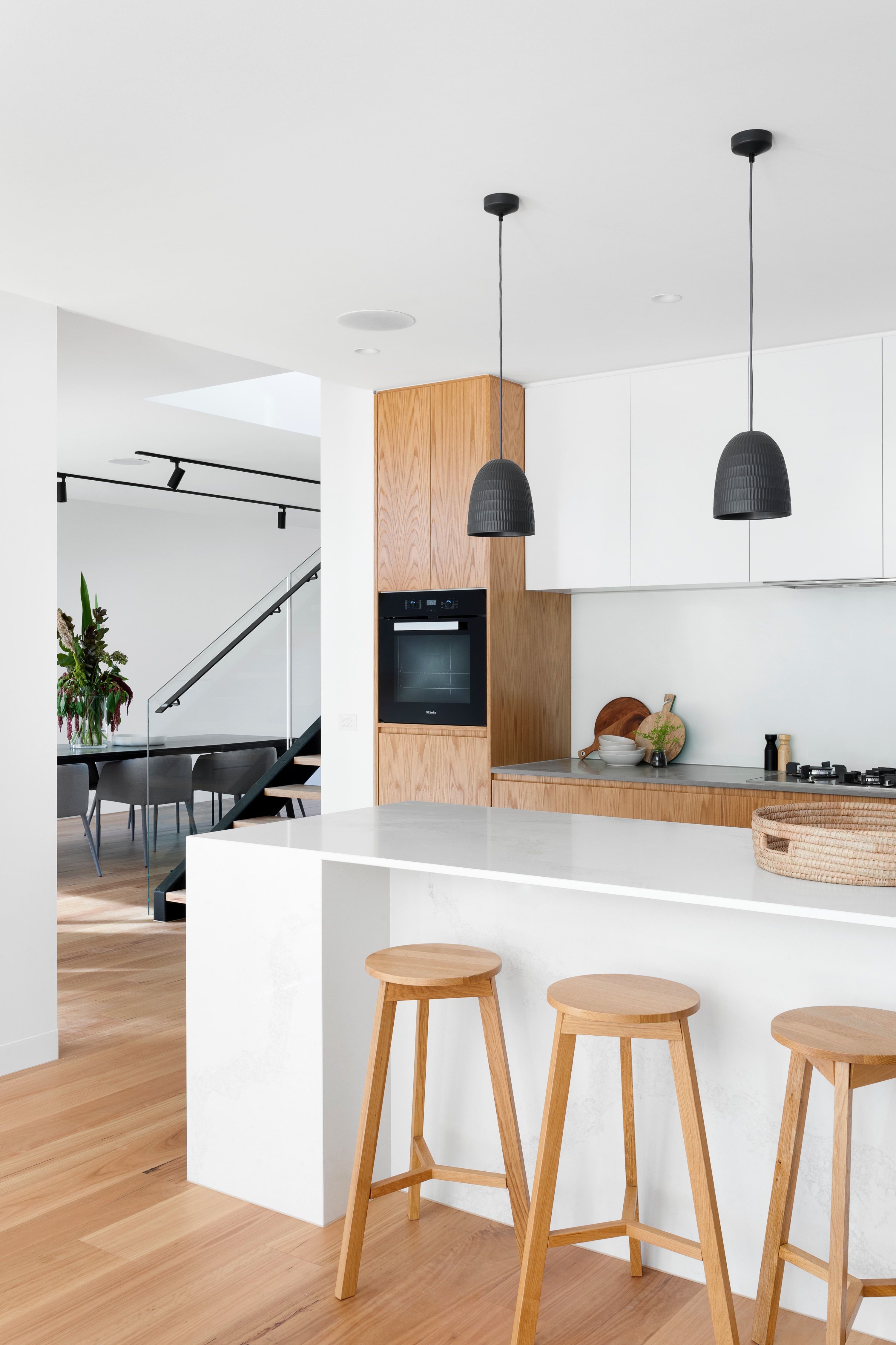 white kitchen with black accents and open space concept  - photo by Unsplash