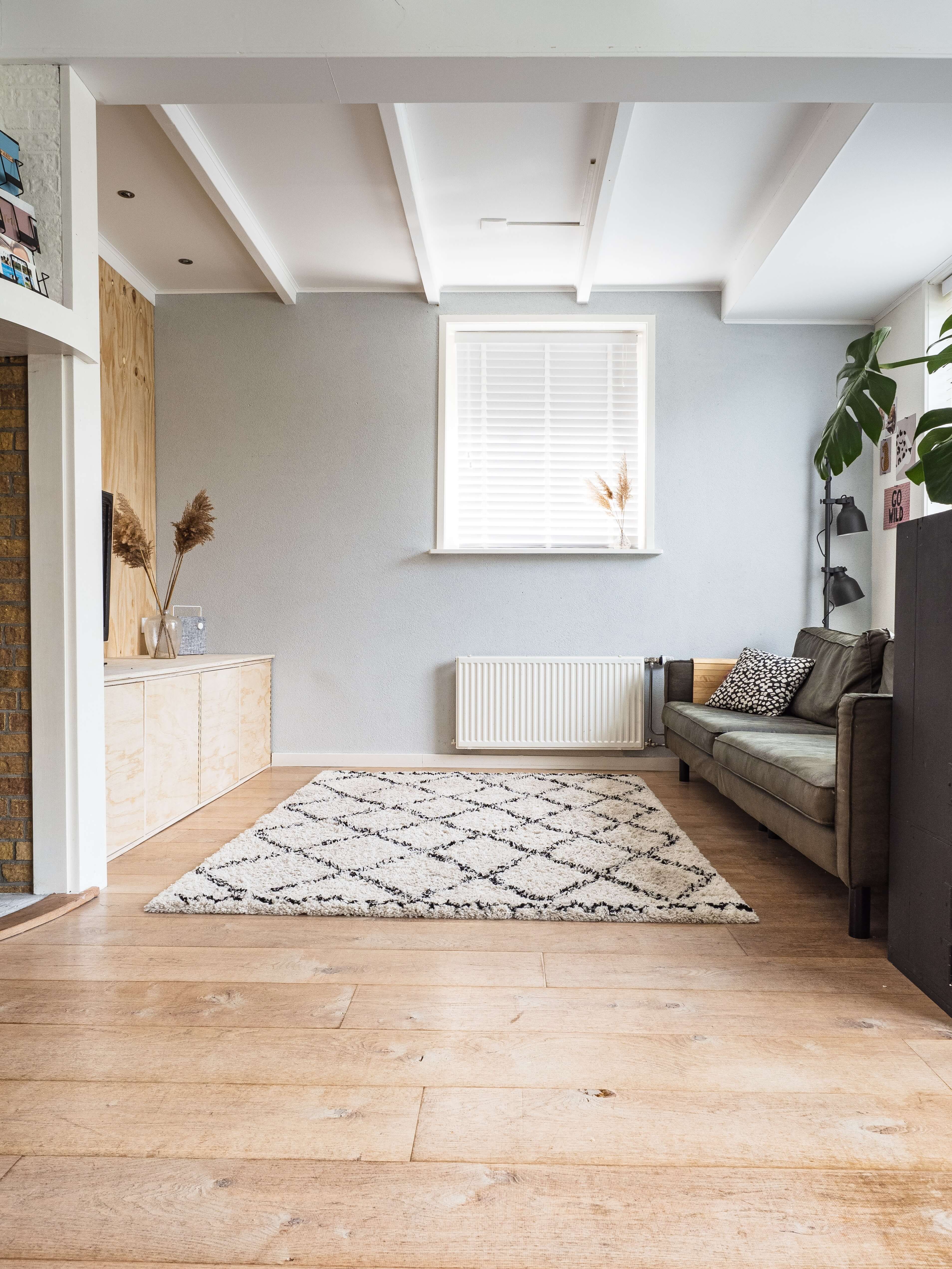 open room with window & pattered rug in front of sofa open room with window & pattered rug in front of sofa